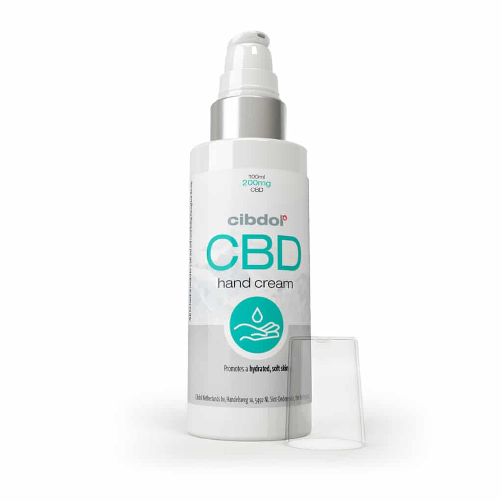 une bouteille de crème pour les mains cbd à côté d'un récipient.